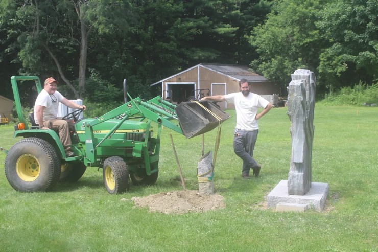 Landon Knittweis and Ryan Martin move artwork in anticipation for upcoming construction